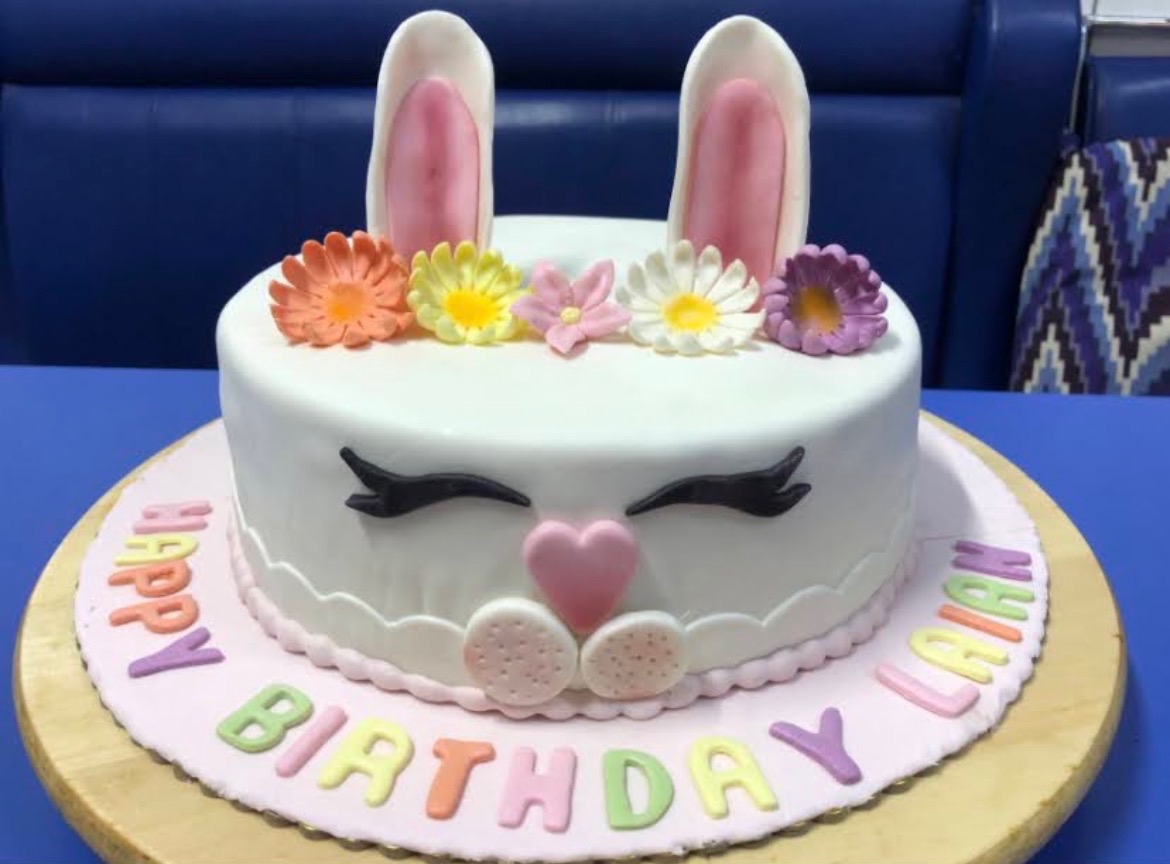 Elegant white cake with sugar flower topper