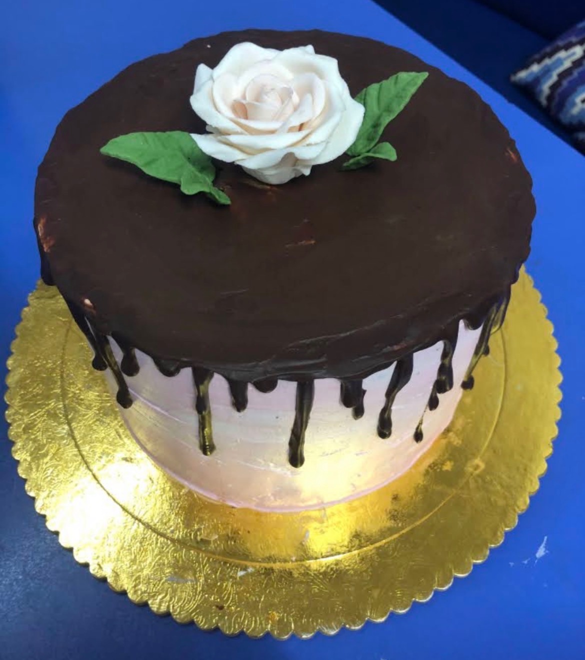Chocolate drip cake with white sugar rose