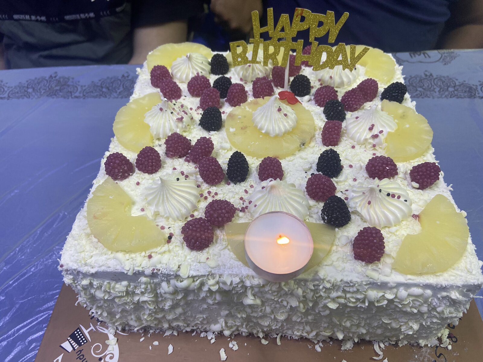 Chocolate birthday cake with gold leaf accents